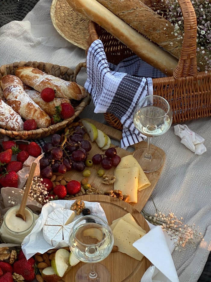Menu Lavish picnic setting with wine, cheese, fresh bread, and fruits in Sochi, Russia.